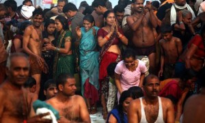 Hindu devotees pray as they bathe in the Sangham during the Kumbh Mela in Allahabad